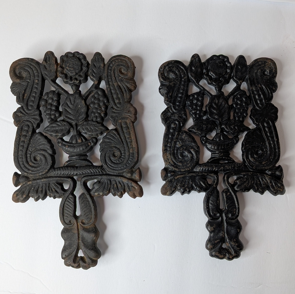 2 VINTAGE CAST IRON TRIVETS 8 INCHES LONG X 4.5 INCHES WIDE X 1 INCH TALL